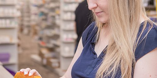 Pharmacy technician pours tablets
