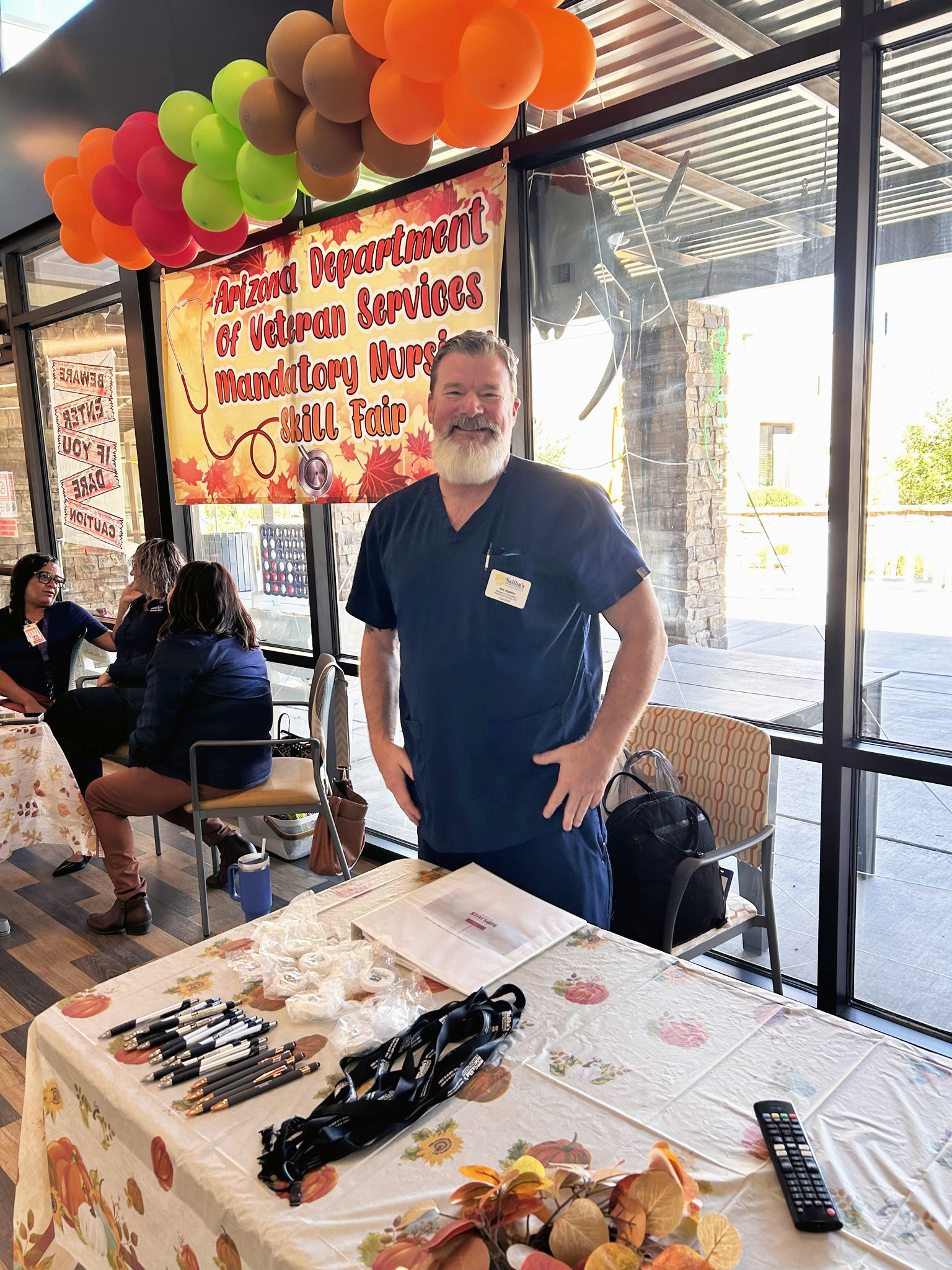 Rick England standing in front of a table at a skills fair