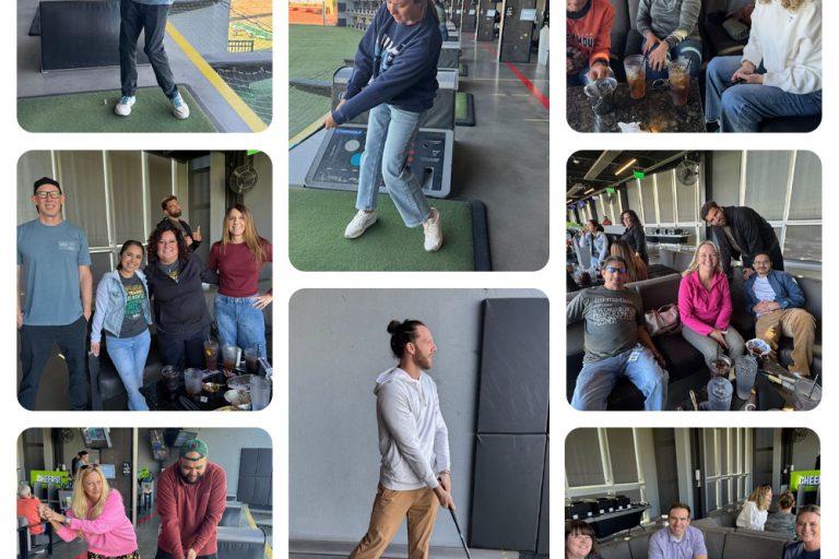 Employees sitting together and playing golf.