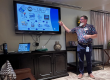 Man doing a presentation in front of a crowd.