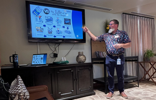 Man doing a presentation in front of a crowd.