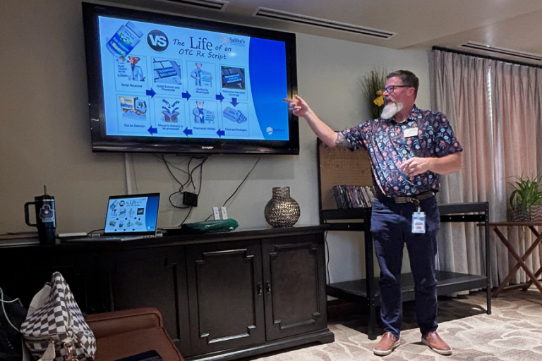 Man doing a presentation in front of a crowd.