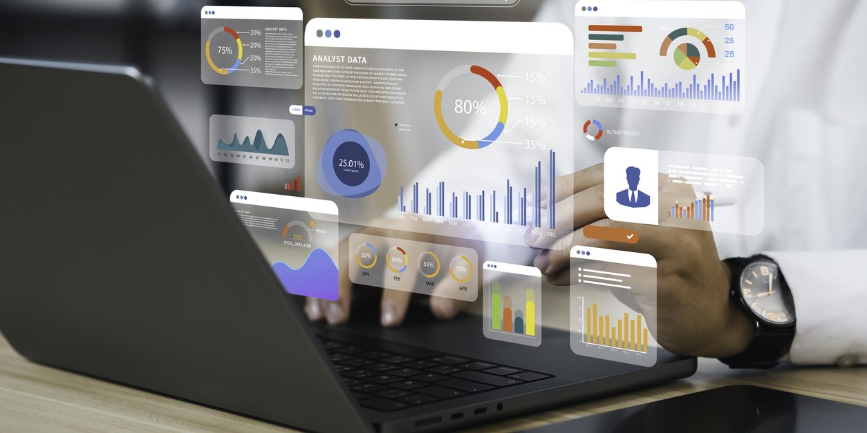 A person uses a computer and dashboard for data business analysis and Data Management System with KPI and metrics connected to the database for technology finance, operations