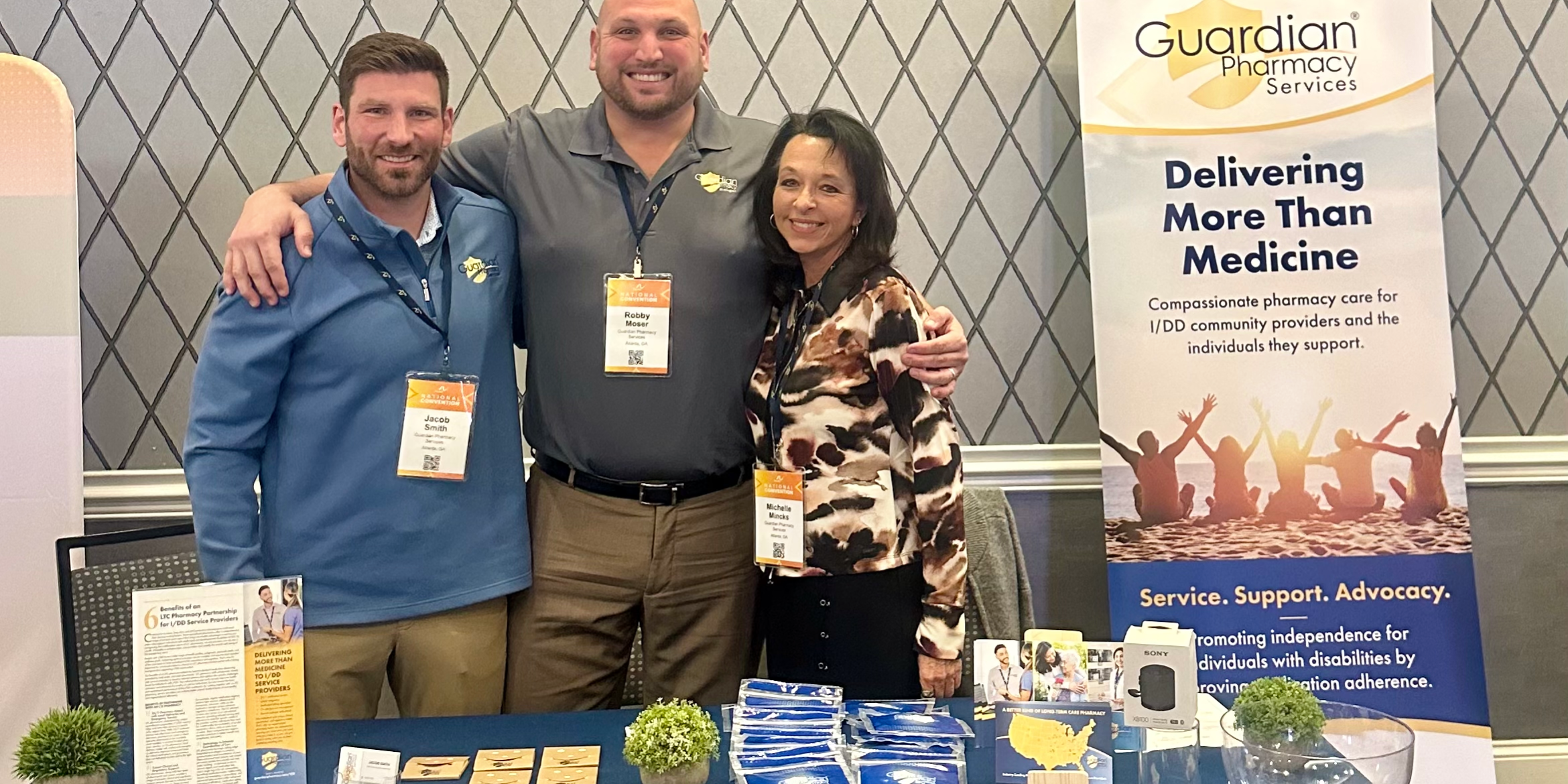 Guardian Pharmacy employees at a booth table at the Arc Convention