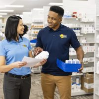 Two pharmacy technicians collaborating in a professional pharmacy setting.