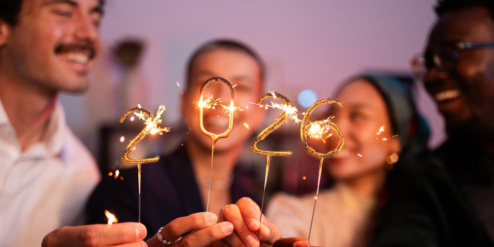 Group of friends celebrating the new year 2026 together with sparklers