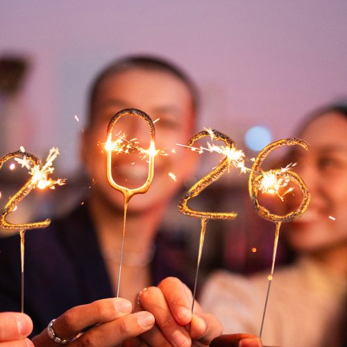 Group of friends celebrating the new year 2026 together with sparklers